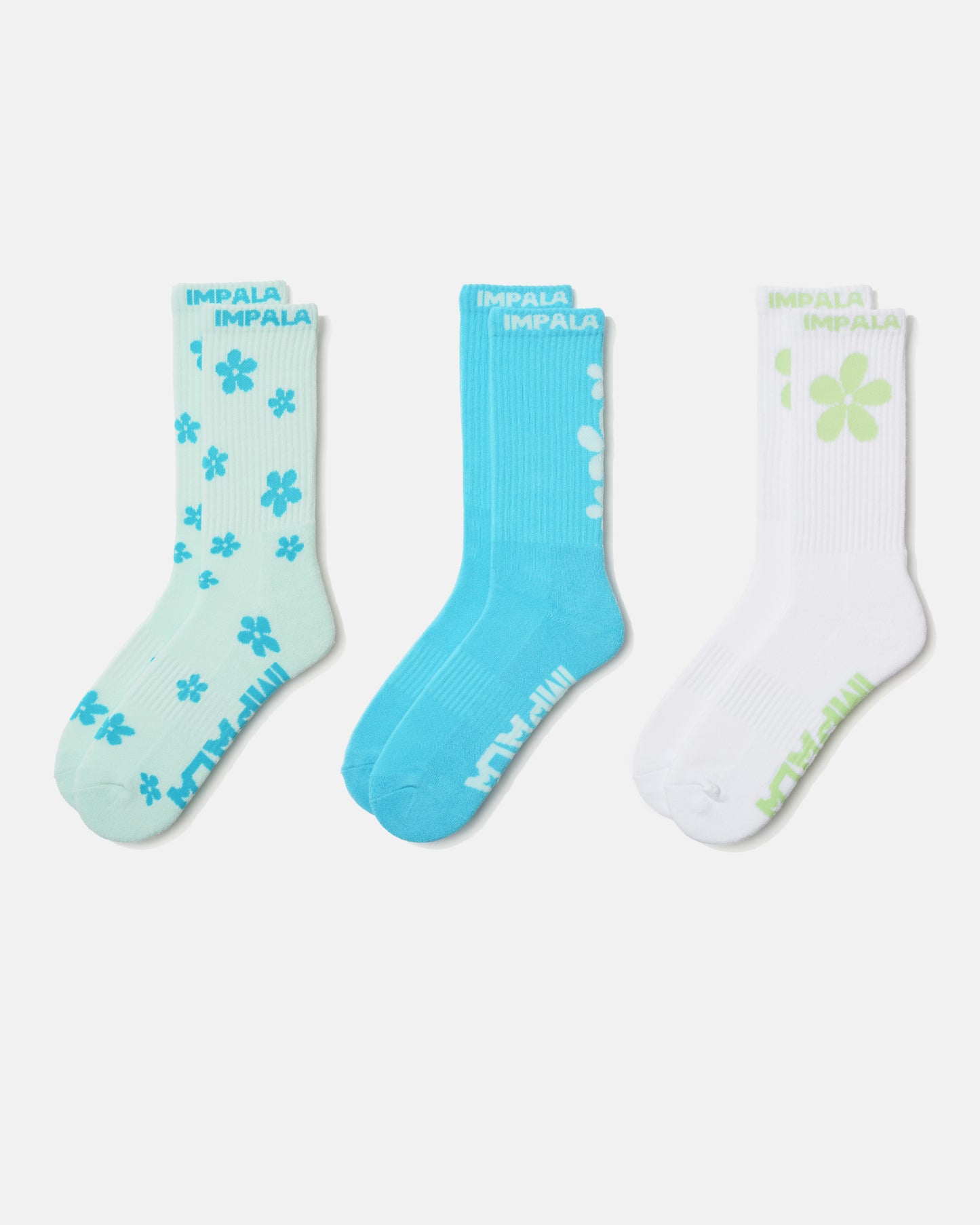 Three pairs of socks with floral patterns on a white background