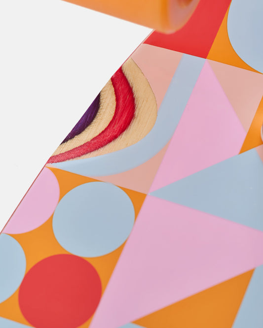 Close up of vibrant geometric deck art with orange pink purple and blue shapes