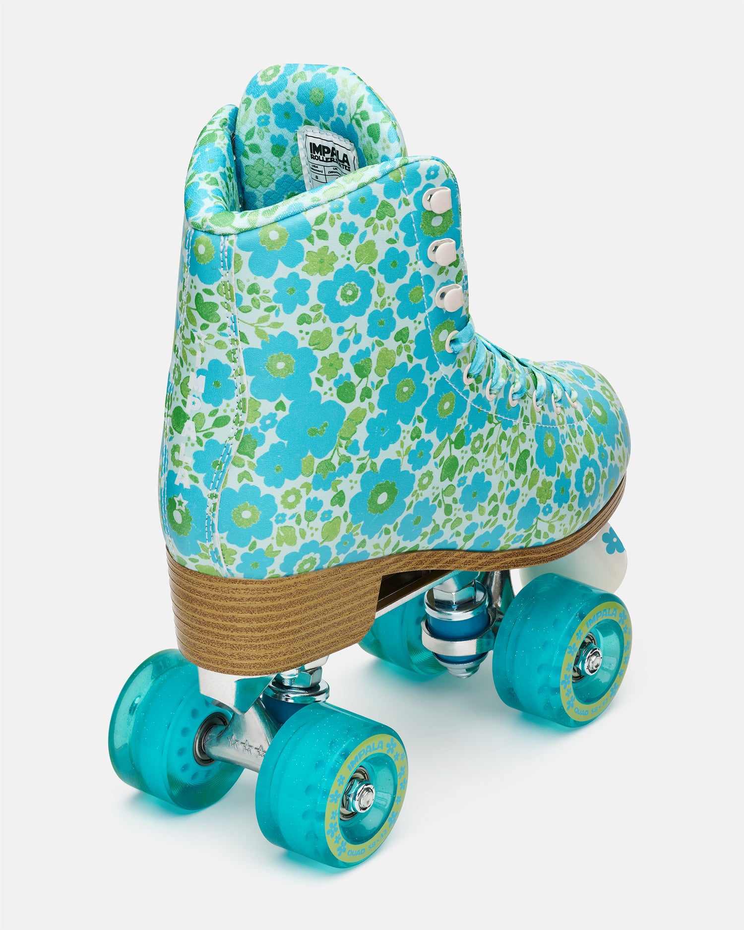 Floral-patterned roller skate with turquoise wheels on a white background