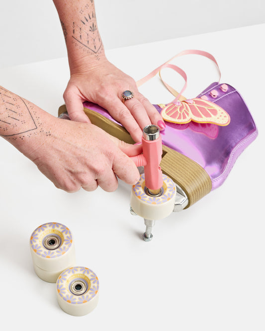 Studio image of person setting up the Impala Quad Rink Riot Whl 4pk - Off White.
