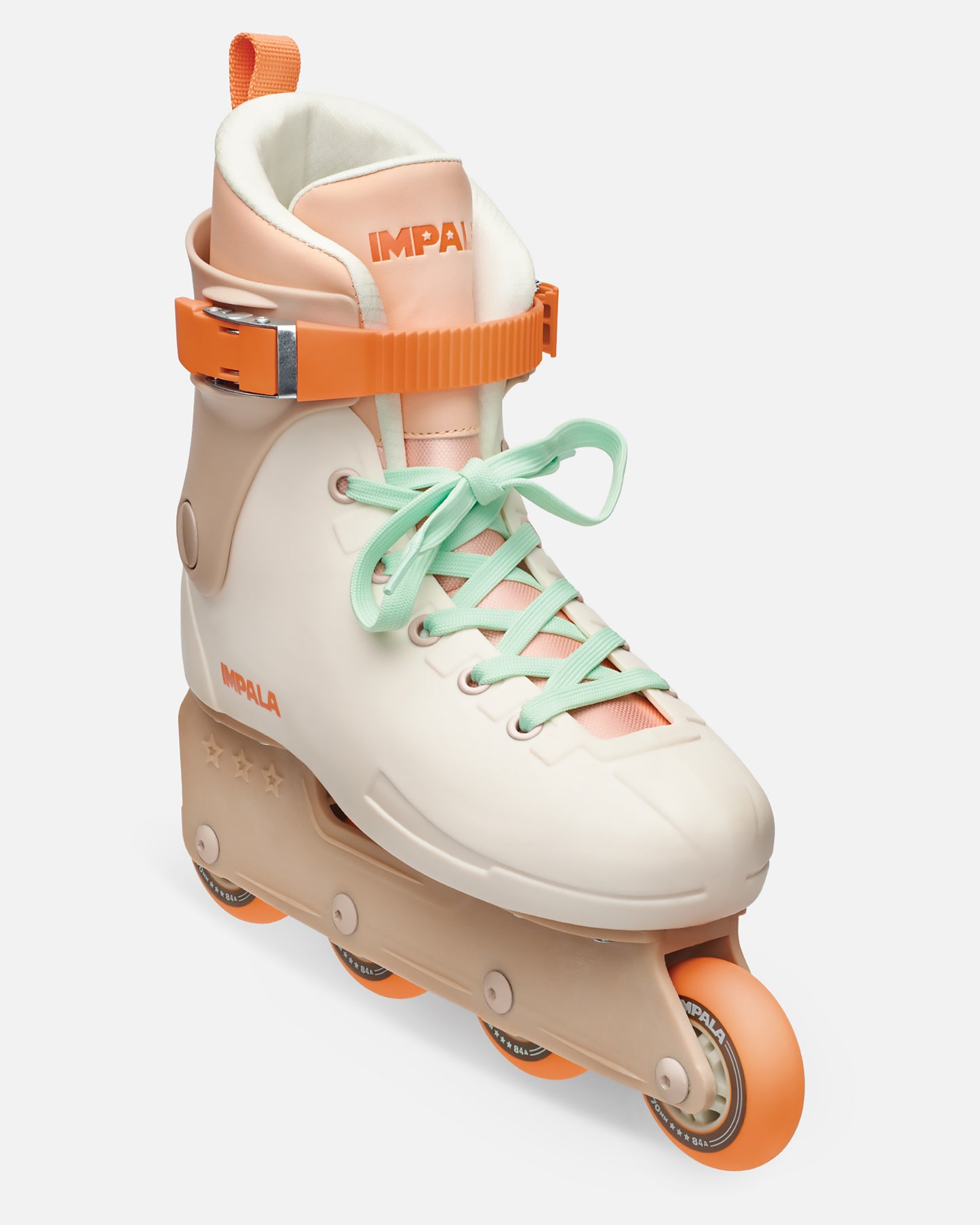 Sahara inline skate close up showing peach shell, white padded collar, bright orange strap buckle, mint laces, and orange wheels.