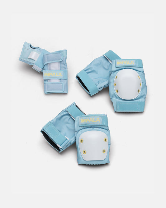 Sky blue and yellow protective set components laid flat showing knee and elbow pads with white shells