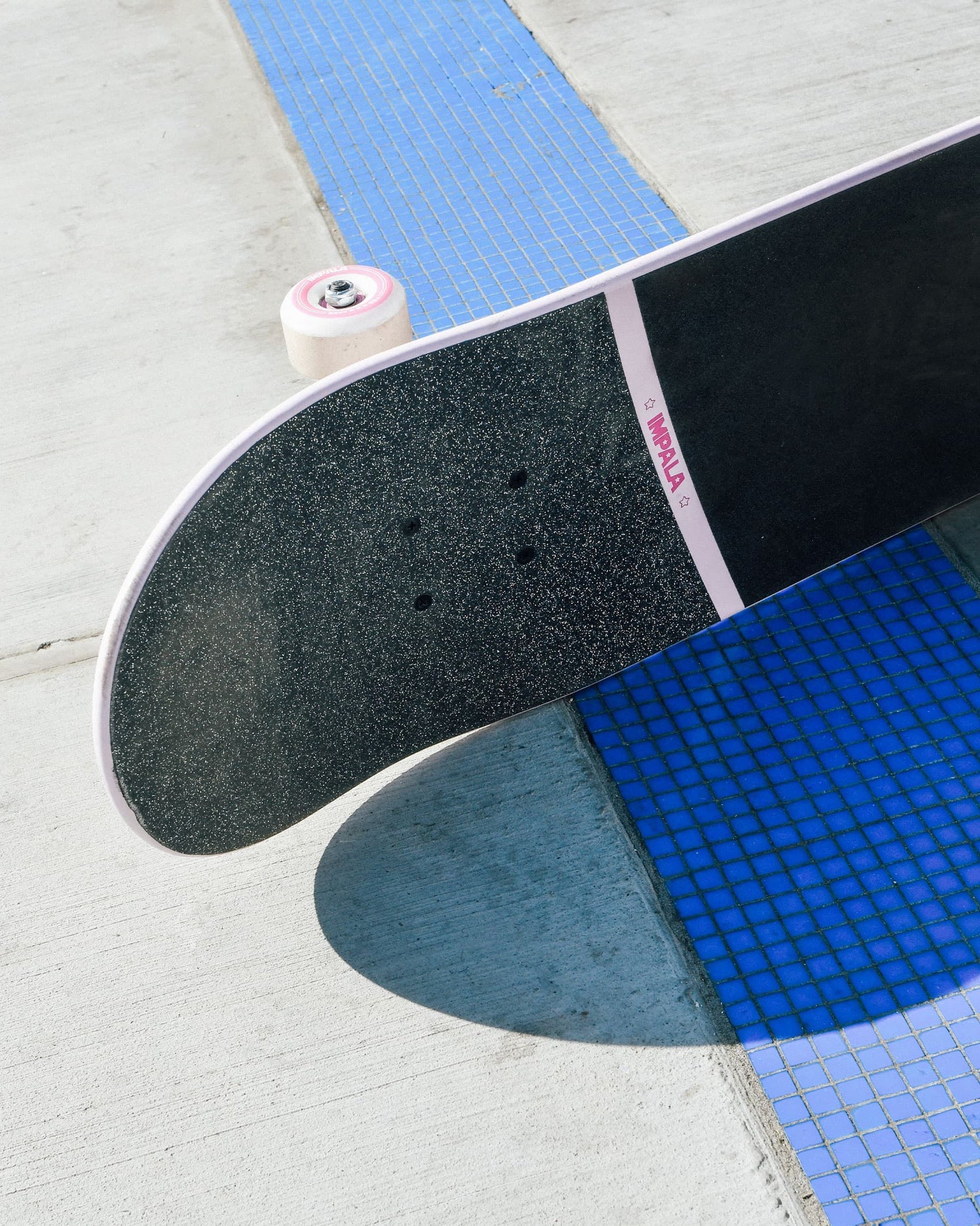Life style profile shot of Impala Cosmos Skateboard - Pink